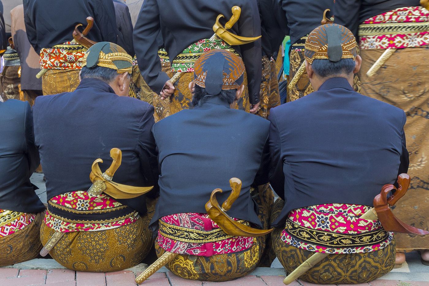 Kelompok pria memakai seragam batik seragam